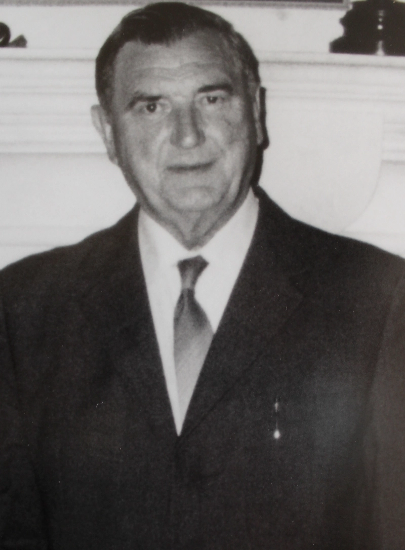 Black-and-white portrait of a man wearing a suit and tie